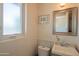 Charming bathroom with a modern vanity, stylish fixtures, framed mirror, and a frosted glass window at 4502 N 17Th Ave, Phoenix, AZ 85015