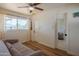 Bright bedroom featuring wood-look floors, a ceiling fan, and a large window for plenty of natural light at 4502 N 17Th Ave, Phoenix, AZ 85015