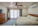 Bright bedroom featuring a ceiling fan, wooden bed frame, and ample natural light at 4502 N 17Th Ave, Phoenix, AZ 85015