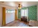 Eclectic bedroom design with bold wallpaper, wood floors, and a ceiling fan at 4502 N 17Th Ave, Phoenix, AZ 85015