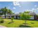 Quaint single-story house featuring lush green lawn and landscaping with trees, creating a tranquil neighborhood setting at 4502 N 17Th Ave, Phoenix, AZ 85015