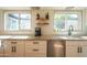 Bright kitchen with white cabinets, granite countertops, and a stainless steel dishwasher creating a clean and functional space at 4502 N 17Th Ave, Phoenix, AZ 85015