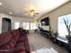 Well-lit living room featuring neutral colors, carpet, a ceiling fan and natural light at 4601 W Fortune Dr, Anthem, AZ 85086