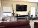 Comfortable living room with a television, plants, an aquarium and natural light at 4601 W Fortune Dr, Anthem, AZ 85086