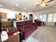 Spacious living room featuring neutral colors, ceiling fan, carpet, and an adjoining kitchen at 4601 W Fortune Dr, Anthem, AZ 85086