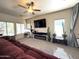 Bright living room featuring a television, plants, neutral colors, and plenty of natural light at 4601 W Fortune Dr, Anthem, AZ 85086