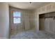 Unfinished bedroom features drywall, window, door and closet, ready for personalization at 46887 W Old Timer Rd, Maricopa, AZ 85139