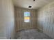 Unfinished bedroom with bare drywall and window, offering a blank canvas for customization at 46887 W Old Timer Rd, Maricopa, AZ 85139