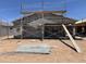 Exterior of home under construction showing stucco, roofline, and construction site materials at 46887 W Old Timer Rd, Maricopa, AZ 85139