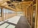 Interior framing reveals the layout and construction of an open living space with natural light and backyard views at 46887 W Old Timer Rd, Maricopa, AZ 85139