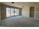 Spacious living room under construction featuring drywall walls and large sliding glass doors to outdoor area at 46887 W Old Timer Rd, Maricopa, AZ 85139