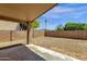 Gravel backyard with block fence and covered patio at 4723 W Samantha Way, Laveen, AZ 85339