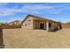 Wide open backyard with beige stucco exterior and a covered patio that provides shade and comfort at 4723 W Samantha Way, Laveen, AZ 85339