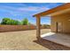Gravel backyard with block fence and covered patio at 4723 W Samantha Way, Laveen, AZ 85339