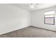 Bedroom features plush carpeting, ceiling fan, and window allowing for natural light at 4723 W Samantha Way, Laveen, AZ 85339