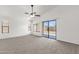 Bright bedroom with carpet, fan, and sliding glass door to backyard at 4723 W Samantha Way, Laveen, AZ 85339
