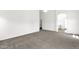 Spacious carpeted bedroom featuring an arched doorway and neutral color palette at 4723 W Samantha Way, Laveen, AZ 85339