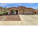 Charming single-story home with a well-maintained lawn and a spacious three car driveway at 4723 W Samantha Way, Laveen, AZ 85339