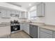 Light kitchen with stainless steel appliances, gray cabinets, and tile flooring at 4723 W Samantha Way, Laveen, AZ 85339