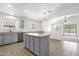Bright kitchen with gray cabinets, tile floors, an island, and stainless steel appliances at 4723 W Samantha Way, Laveen, AZ 85339