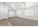 Bright living room with neutral walls, carpet floors, and shuttered windows at 4723 W Samantha Way, Laveen, AZ 85339