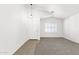 Bright living room with neutral walls, carpet floors, and shuttered windows at 4723 W Samantha Way, Laveen, AZ 85339