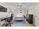 Bright bedroom features a ceiling fan, wood floors, and a stylish blue rug at 4901 S Calle Los Cerros Dr # 119, Tempe, AZ 85282