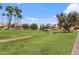 Expansive green community grounds with picnic tables, mature trees, and walking paths at 4901 S Calle Los Cerros Dr # 119, Tempe, AZ 85282