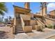 View of a townhouse featuring stairs leading to the upper level, set in a well-maintained complex with greenery at 4901 S Calle Los Cerros Dr # 119, Tempe, AZ 85282