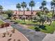 View of well maintained townhomes, enhanced by lush landscaping and majestic palm trees, set against a sunny sky at 4901 S Calle Los Cerros Dr # 119, Tempe, AZ 85282