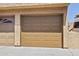 Beige garage door with paneled design in a textured stucco exterior at 4901 S Calle Los Cerros Dr # 119, Tempe, AZ 85282