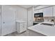 Modern kitchen featuring white cabinets, stainless steel appliances, quartz counters, and ample storage space at 4901 S Calle Los Cerros Dr # 119, Tempe, AZ 85282