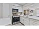 Contemporary kitchen featuring white cabinets, stainless steel appliances, quartz counters, and modern finishes at 4901 S Calle Los Cerros Dr # 119, Tempe, AZ 85282