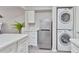 Modern kitchen with white quartz countertops, stainless steel appliances, and a convenient washer/dryer unit at 4901 S Calle Los Cerros Dr # 119, Tempe, AZ 85282