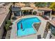 Aerial view of sparkling pool, landscaped yard, outdoor seating and pool house at 5543 W Kowalsky Ln, Laveen, AZ 85339