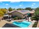 Aerial view of backyard featuring a pool, and outdoor patio area with seating and grill at 5543 W Kowalsky Ln, Laveen, AZ 85339