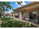 Inviting outdoor living space with covered patio, lush lawn, and sparkling pool at 5543 W Kowalsky Ln, Laveen, AZ 85339