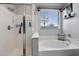 Bright bathroom featuring a walk-in shower and soaking tub beneath a window for natural light at 5543 W Kowalsky Ln, Laveen, AZ 85339