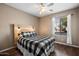 Relaxing bedroom featuring a wood headboard, neutral walls, and a bright window at 5543 W Kowalsky Ln, Laveen, AZ 85339
