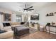 Cozy living room with comfortable seating, a large TV, and stylish decor at 5543 W Kowalsky Ln, Laveen, AZ 85339