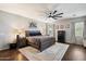 Serene main bedroom featuring a ceiling fan, ample natural light, and neutral decor at 5543 W Kowalsky Ln, Laveen, AZ 85339
