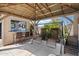 Relaxing patio area complete with outdoor bar, swing, and seating for enjoying the beautiful weather at 5543 W Kowalsky Ln, Laveen, AZ 85339