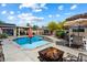 Backyard features a sparkling pool, outdoor seating and fire pit, perfect for entertaining at 5543 W Kowalsky Ln, Laveen, AZ 85339
