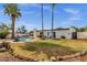 Expansive backyard features a sparkling pool, patio seating, lush greenery, and mature trees, perfect for entertaining and relaxation at 6401 E Voltaire Ave, Scottsdale, AZ 85254