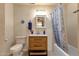 Bathroom with wooden vanity, toilet, and shower-tub combination at 6401 E Voltaire Ave, Scottsdale, AZ 85254