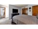 Bedroom with a television and a view into the bathroom and closet at 6401 E Voltaire Ave, Scottsdale, AZ 85254