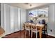 Bright dining area features large windows, hardwood flooring, and a stylish light fixture at 6401 E Voltaire Ave, Scottsdale, AZ 85254