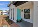Close up of a blue front door of stucco home with brick trim and desert landscaping at 6401 E Voltaire Ave, Scottsdale, AZ 85254