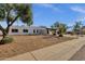 Wide angle view of a white stucco home showcasing the drought resistant landscaping at 6401 E Voltaire Ave, Scottsdale, AZ 85254