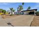 Front of a stucco home featuring a black carport and desert landscaping at 6401 E Voltaire Ave, Scottsdale, AZ 85254